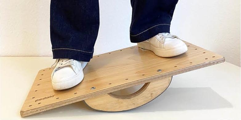Theaterstück 'Haltungswechsel': 9. November 2026 Das Bild zeigt zwei Beine in weißen Turnschuhen, die auf einem Balanceboard stehen.